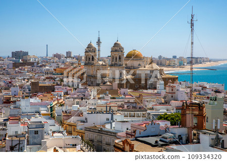 Aerial panoramic view of the old city rooftops and Cathedral de Santa Cruz in the afternoon from tower Tavira in Cadiz, Andalusia, Spain 109334320