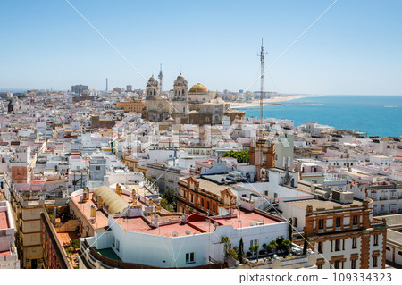 Aerial panoramic view of the old city rooftops and Cathedral de Santa Cruz in the afternoon from tower Tavira in Cadiz, Andalusia, Spain 109334323