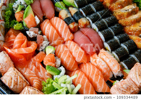 Assorted Sushi Nigiri and Maki Big Set on Slate. A Variety of Japanese Sushi with Tuna, Crab, Salmon, Eel, and Rolls. Top View. Assorted Sushi Nigiri and Maki Big Set on Slate. A Variety of Japanese Sushi with Tuna, Crab, Salmon, Eel, and Rolls. Top View. 109334489