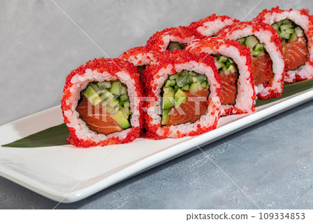 Sushi and rolls with caviar, shrimp and tuna, avocado on a gray background. 109334853