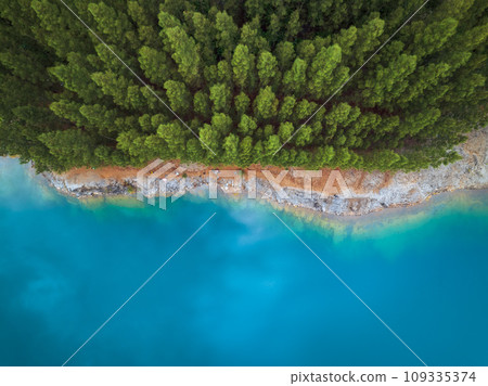 Aerial drone top view of blue pond with pine tree in a rainforest, Phang Nga, Thailand 109335374