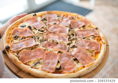 Pizza with ham and mushrooms homemade tasty italian. 109335429