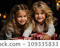 Happy little kids with a festive red and white Christmas gift 109335833