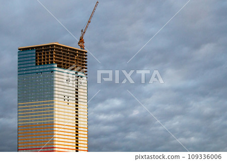 construction of high-rise building with cloudy sky 109336006