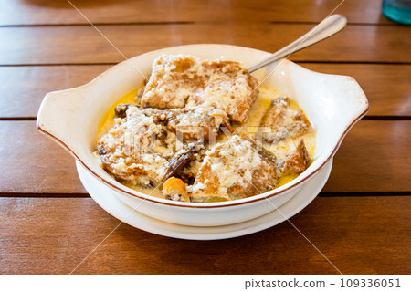 Chkmeruli chicken fried in creamy garlic sauce Chkmeruli chicken fried in creamy garlic sauce 109336051