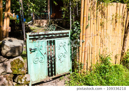 bamboo fence and old gate to rural yard in village 109336218