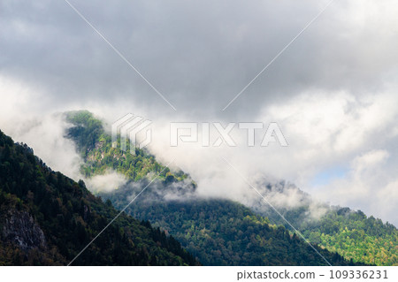 gray clouds lie on tops of mountains in Adjara 109336231