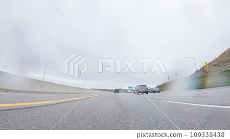 Amidst a rainy winter day, driving on HWY 134 near Los Angeles, California, captures the atmosphere through raindrop-covered lenses, adding a unique and moody perspective to the journey. Amidst a rainy winter day, driving on HWY 134 near Los Angeles, California, captures the atmosphere through raindrop-covered lenses, adding a unique and moody perspective to the journey. 109338438