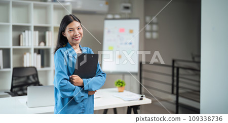 Business woman standing in an office with a smile, mission and vision in the office. management and success with corporate business people at work Business woman standing in an office with a smile, mission and vision in the office. management and success with corporate business people at work 109338736