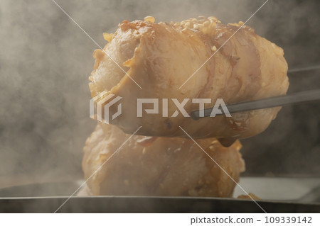 Meat-wrapped rice ball with chopsticks 109339142