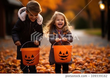 Children Trick Or Treating with Jack-O-Lantern Candy Buckets on Halloween Children Trick Or Treating with Jack-O-Lantern Candy Buckets on Halloween 109339182