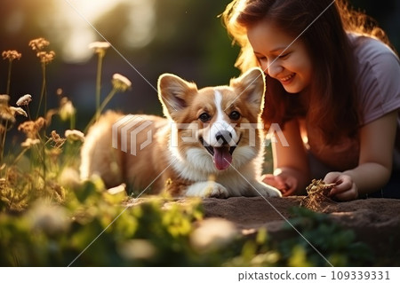 Young girl playing with happy Welsh Corgi dog in the park on a sunny summer day. Generative AI 109339331