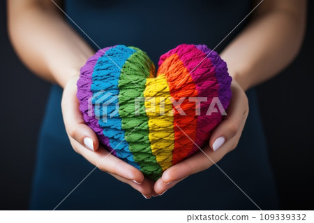 Hands hold heart in the colors of rainbow on light blue background. LGBT concept. Generative AI Hands hold heart in the colors of rainbow on light blue background. LGBT concept. Generative AI 109339332