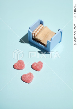 Pattern of gummy vitamin candy in shape of heart on blue background. Concept. Pattern of gummy vitamin candy in shape of heart on blue background. Concept. 109340262