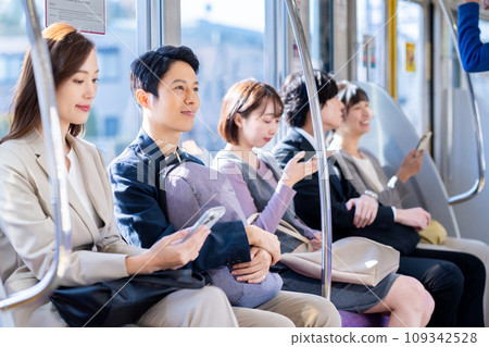 Businessman on a commuter train Photography cooperation: Keio Electric Railway Co., Ltd. Businessman on a commuter train Photography cooperation: Keio Electric Railway Co., Ltd. 109342528