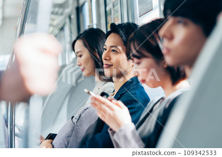 Businessman on a commuter train Photography cooperation: Keio Electric Railway Co., Ltd. Businessman on a commuter train Photography cooperation: Keio Electric Railway Co., Ltd. 109342533
