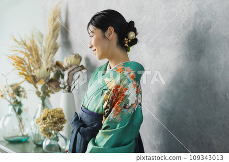 A woman wearing a furisode and hakama A woman wearing a furisode and hakama 109343013