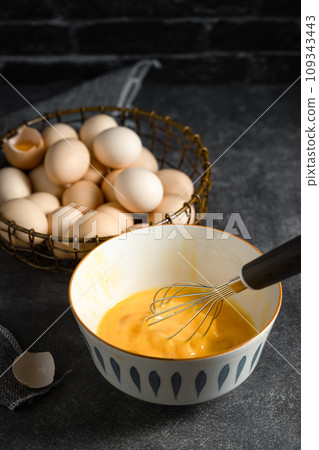 Whisk eggs in bowl Whisk eggs in bowl 109343443