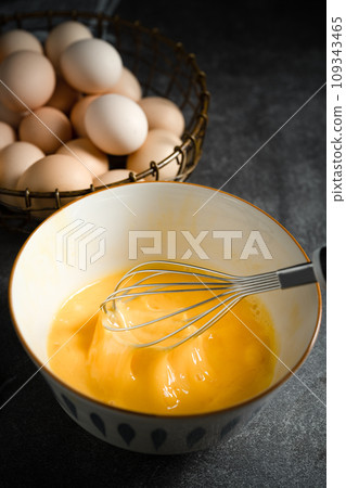 Whisk eggs in bowl 109343465