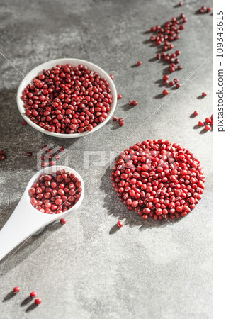Red adzuki beans on black background plate Red adzuki beans on black background plate 109343615