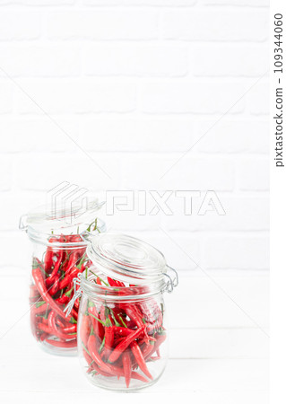 red chili peppers in a glass jar red chili peppers in a glass jar 109344060