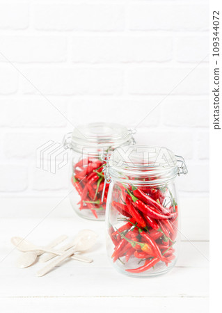 red hot chili peppers in glass jar red hot chili peppers in glass jar 109344072