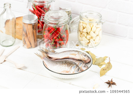 dried fish and spices in bottle 109344565