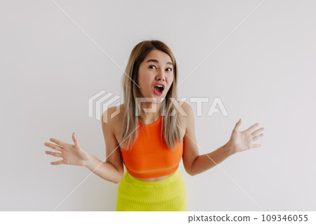 Shocked and surprised face of woman in orange lemon isolated on white. 109346055