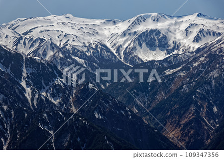 Mitsumata Renge-dake and Washu-dake with remaining snow seen from the Tsubaku-dake ridge in the Northern Alps Mitsumata Renge-dake and Washu-dake with remaining snow seen from the Tsubaku-dake ridge in the Northern Alps 109347356