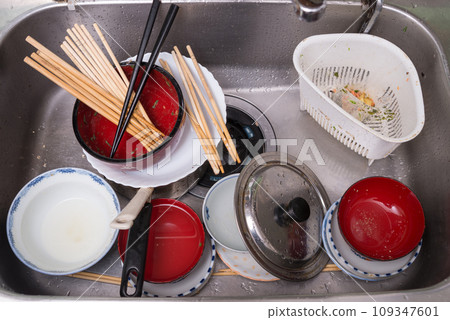 Eating dishes placed in the sink 109347601