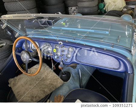 This is an image of the driver's seat of a light blue-green Triumph TR-3, a classic British car. 109351271