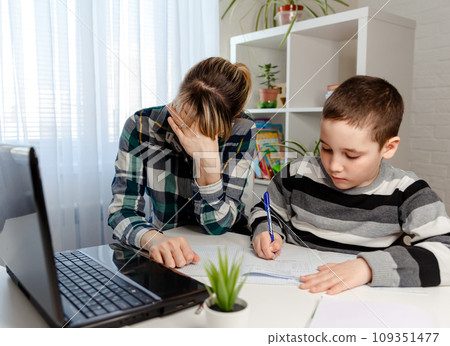 Women working from home with child. Homeschooling and freelance job Women working from home with child. Homeschooling and freelance job 109351477