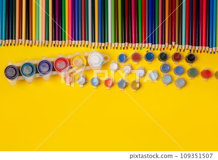 Overhead shot of stationery. Frame of school supplies on yellow paper 109351507