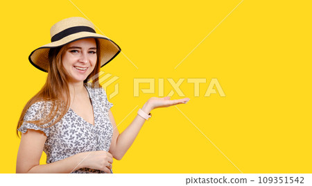 Young happy blonde woman is pointing with hand and finger to the side. 109351542