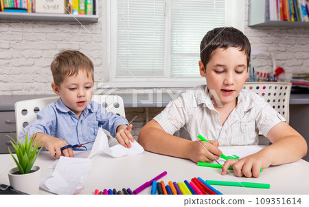Kids draw at home together. Children are painting in kindergarten. Kids draw at home together. Children are painting in kindergarten. 109351614