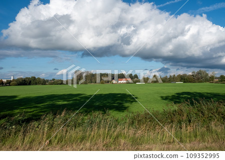 Countryside Bliss: Expansive Fields under Cumulus Clouds Countryside Bliss: Expansive Fields under Cumulus Clouds 109352995
