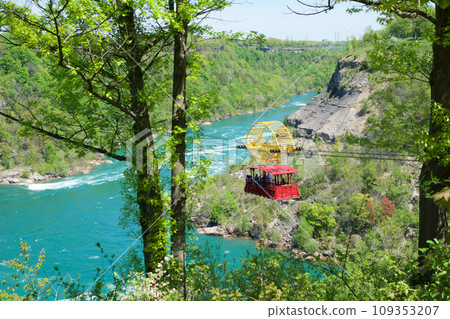 NIAGARA FALLS, ONTARIO, CANADA - MAY 21st 2018: Whirlpool Aero car carrying riders across the Niagara Whirlpool NIAGARA FALLS, ONTARIO, CANADA - MAY 21st 2018: Whirlpool Aero car carrying riders across the Niagara Whirlpool 109353207