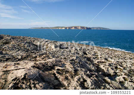 MELLIEHA, MALTA - 01 JAN, 2020: Interesting rock formations along coastline with Mediterranean Sea and Gozo island in the background MELLIEHA, MALTA - 01 JAN, 2020: Interesting rock formations along coastline with Mediterranean Sea and Gozo island in the background 109353221