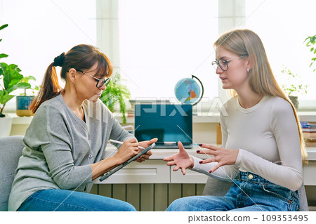 Young teenage girl talking with psychologist, therapist 109353495