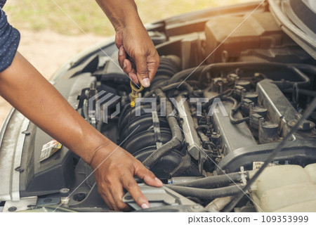 Close up Car Mechanic man hands repairing car auto repair shop. Man hands fixing machinery vehicle mechanical service. open vehicle hood checking up auto mobile. Vehicle Car maintenance engineer. 109353999