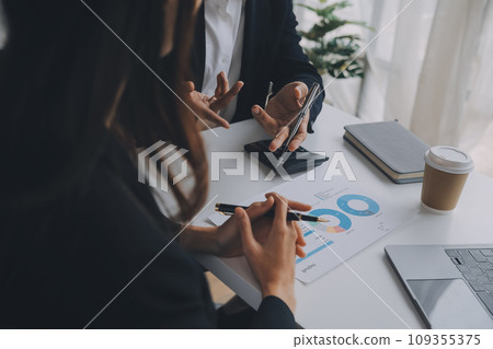 Business professionals. Group of young confident business people analyzing data using computer while spending time in the office 109355375