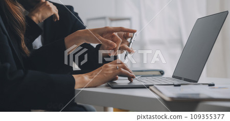Business professionals. Group of young confident business people analyzing data using computer while spending time in the office 109355377