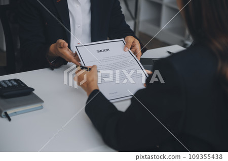 Close up view of job interview in office, focus on resume writing tips, employer reviewing good cv of prepared skilled applicant, recruiter considering application, hr manager making hiring decision 109355438