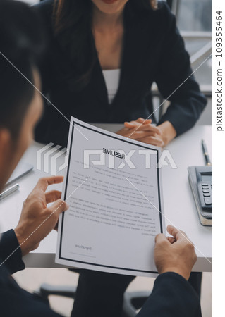 Close up view of job interview in office, focus on resume writing tips, employer reviewing good cv of prepared skilled applicant, recruiter considering application, hr manager making hiring decision Close up view of job interview in office, focus on resume writing tips, employer reviewing good cv of prepared skilled applicant, recruiter considering application, hr manager making hiring decision 109355464