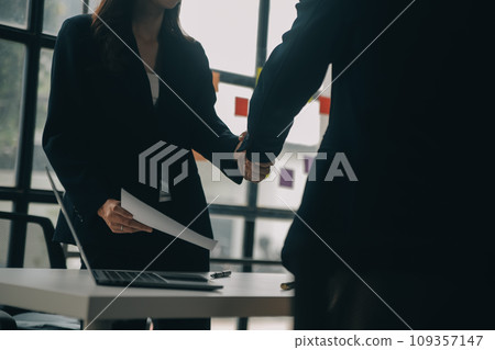 Businessman or job seeker review his resume on his desk before send to finding a new job with pen, necktie, glasses and digital tablet. 109357147
