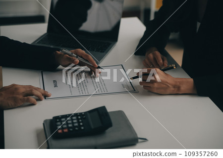 Businessman or job seeker review his resume on his desk before send to finding a new job with pen, necktie, glasses and digital tablet. 109357260