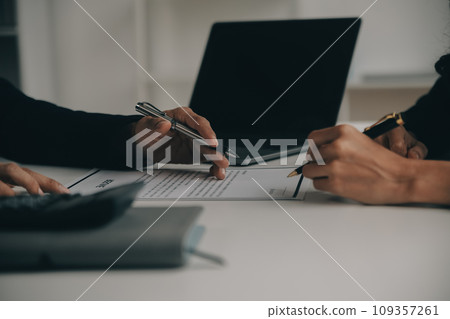 Businessman or job seeker review his resume on his desk before send to finding a new job with pen, necktie, glasses and digital tablet. 109357261