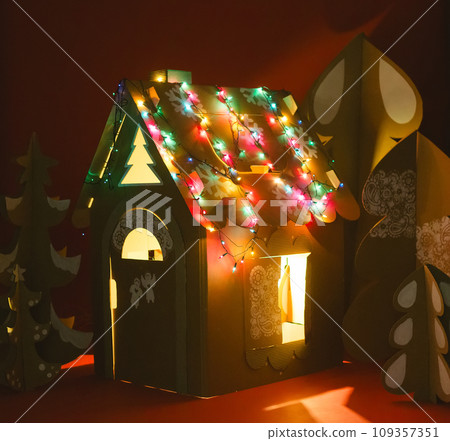 Christmas Tree and Cardboard playhouse Made Of Cardboard. Unique Trees. New Year or Xmas. Christmas Tree and Cardboard playhouse Made Of Cardboard. Unique Trees. New Year or Xmas. 109357351