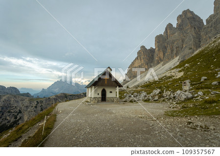 One of the most famous and spectacular views of all the Alps: the locatelli refuge, its church and the three peaks of Lavaredo, inside the Three Peaks-Sesto Dolomites Natural Park 109357567