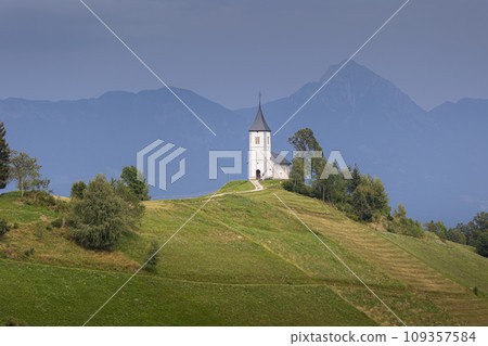 Jamnik, Slovenia. The Jamnik Church is a charming 15th-century chapel in the Kamnik-Savinja Alps near Kranj, breathtaking views of the surrounding mountainous landscape. The Church of St. Primoz 109357584